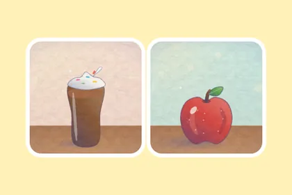 Un batido de chocolate con nata y una manzana roja, dibujados sobre la mesa.